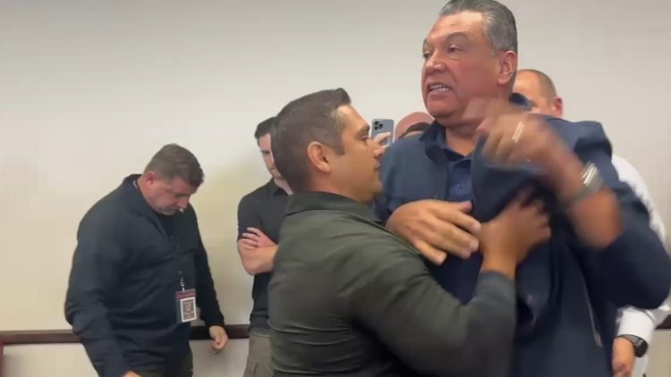 Senator Alex Padilla is removed from the venue after interrupting the press conference held by the secretary of homeland security, Kristi Noem.